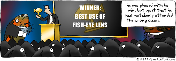 Description: Man receiving award from a fish in front of a fish-crowd. Caption: He was pleased with his win, but upset that he had mistakenly attended the wrong oscars
